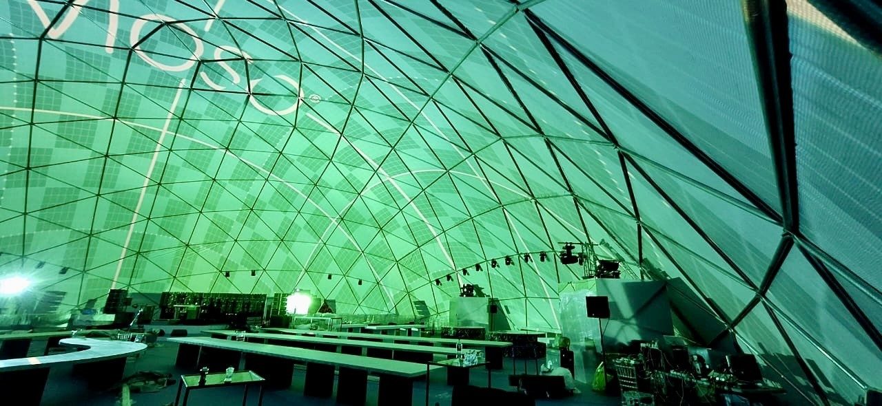 Green branded dome interior with guests