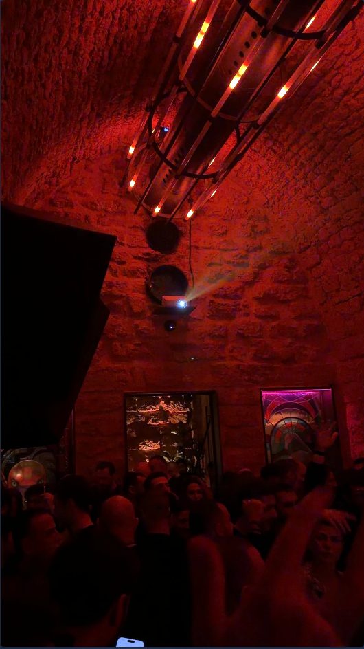Mirror-ball and red wash over vaulted stone