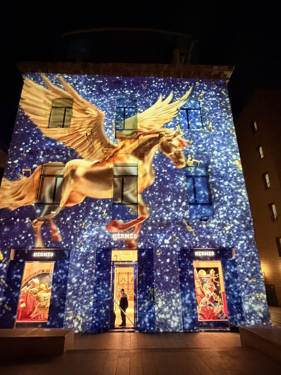 Golden winged horse on starry façade