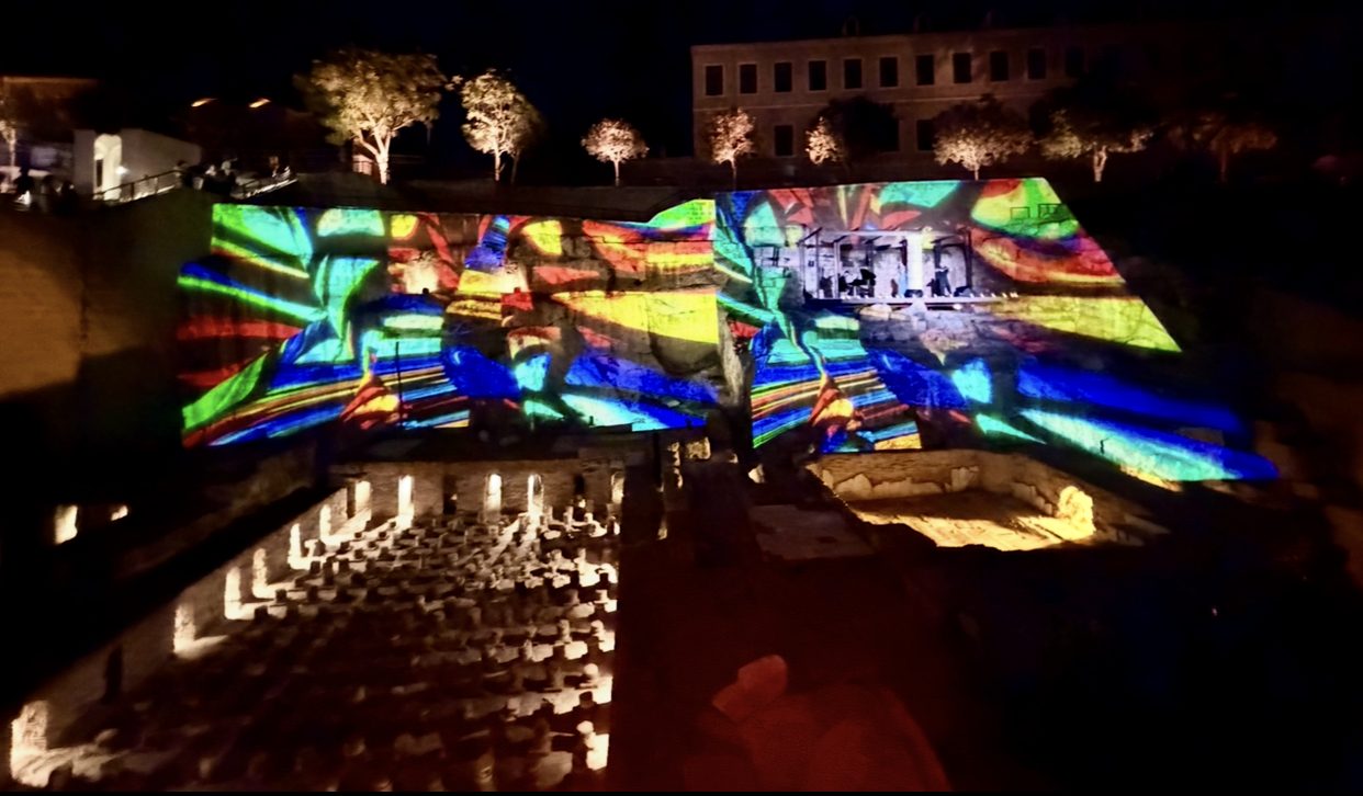 Geometric stained-glass projection on stone