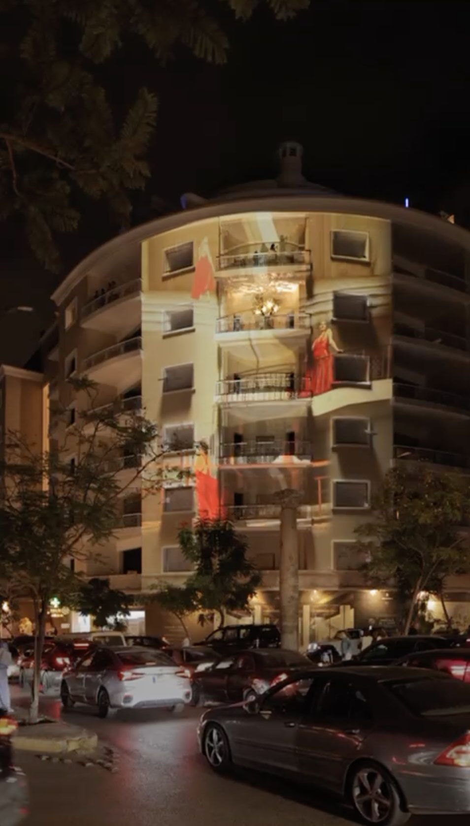 Red dancer figures on the façade balconies