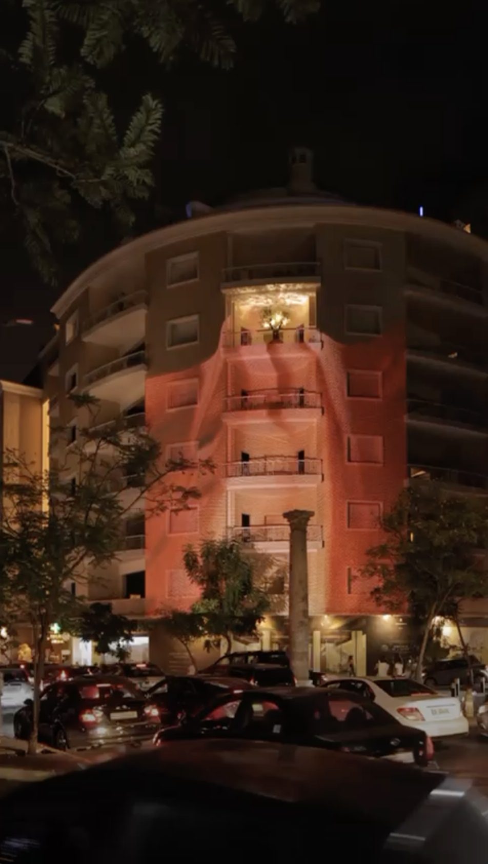 Warm salmon wash across the curved façade